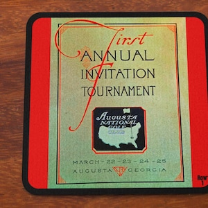 May include: A vintage-style coaster with a red border and a green background. The text "First Annual Invitation Tournament" is printed in black. The logo for Augusta National Golf Club is featured in the center. The dates "March 22-23-24-25" and "Augusta Georgia" are printed below the logo. The text "Row 1" is printed in the lower right corner.