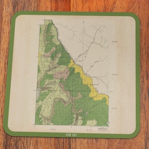 May include: A vintage map of a forest area with green and yellow markings. The map is printed on a cream-colored paper and has a green border. The text "ROW BAY" is printed at the bottom of the map.