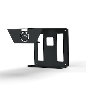 May include: A black metal wall bracket featuring a mountain and flame logo. The bracket has a shelf and a vertical section with cut-out shapes. The design is minimalist and modern, suitable for various applications.