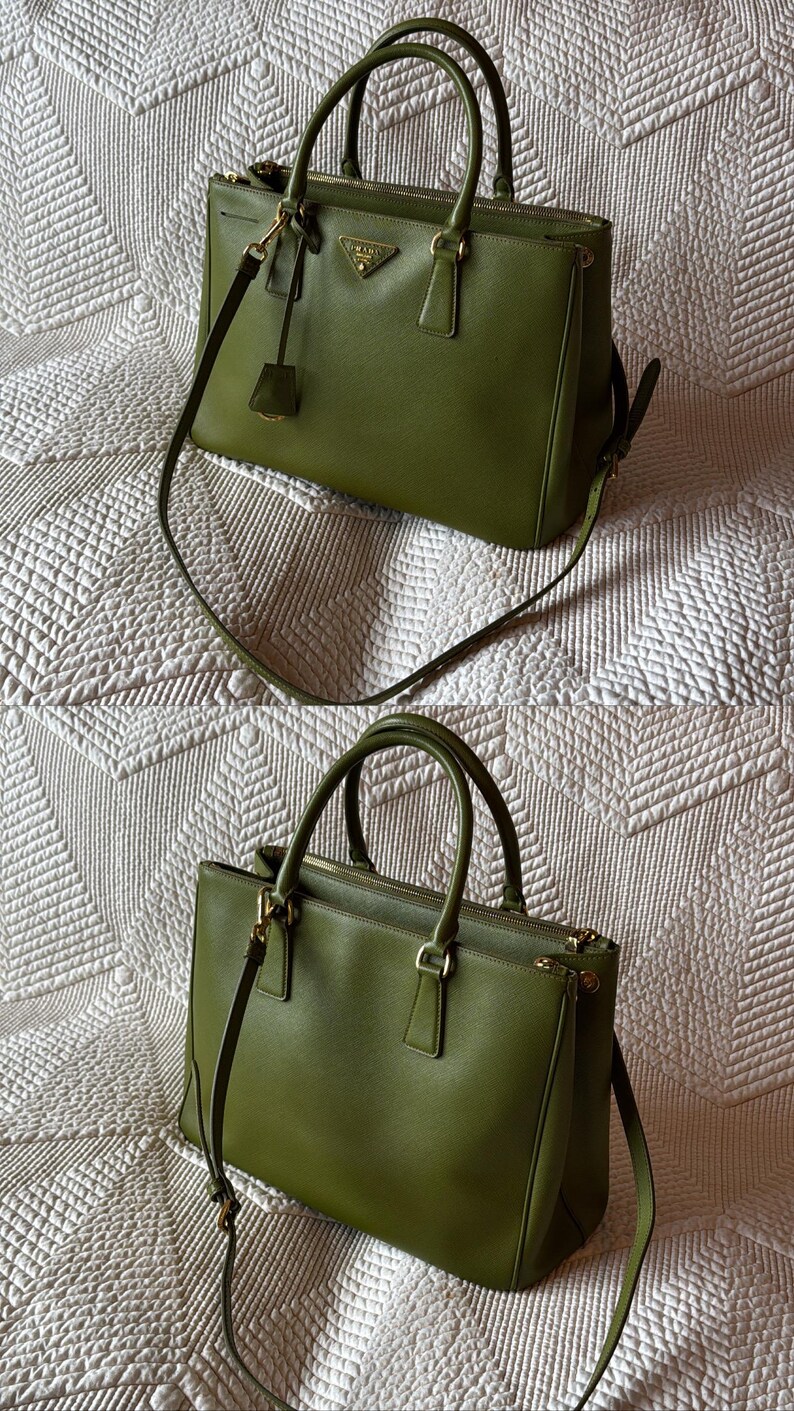 May include: Two olive green handbags with top handles and detachable shoulder straps. The bags have gold-tone hardware and a small triangular logo on the front. The bags are sitting on a white quilted surface.