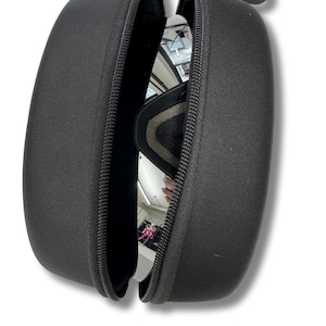 May include: Black zippered case with a pair of mirrored lens goggles inside. The goggles have a black and gray frame. The case is open, revealing the goggles and their reflective lenses. The case has a small black carabiner clip attached.