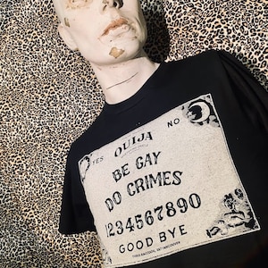 Be gay, do crimes Ouija board tee. t-shirt with a positive message from beyond the grave! for queer punks, goths, metal heads, progressive