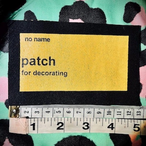 No Name, No Frills generic sew on punk Patch.