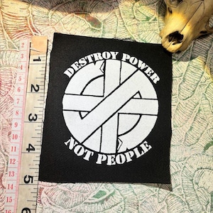 destruir o poder, não as pessoas, logotipo do Crass, patch anarco punk