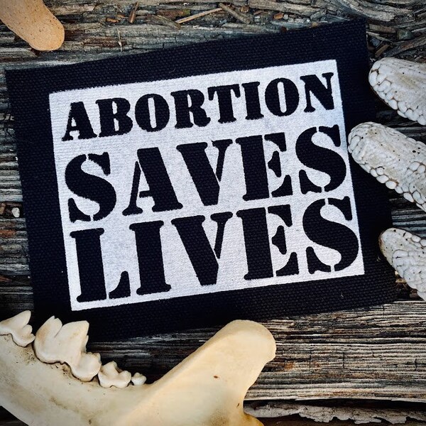 Abortion saves lives. Sew on patch for feminist punk battle vest. Crusty progressive overalls, leftist horror goth backpacks