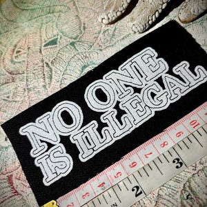 no one is illegal | punk patch | immigrant rights | refugee rights | unhoused rights | leftist progressive | protest | crust punk |