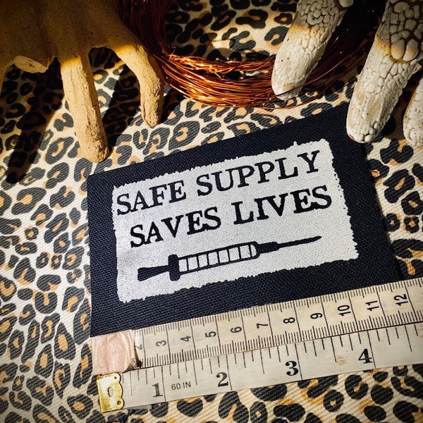 Safe supply saves lives. sew on punk patch for progressive battle vests, crusty leftist overalls, backpacks
