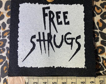 Free Shrugs sew on patch. never mind free hugs, you get free shrugs. for crusty punk battle vests and horror goth backpacks.