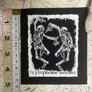 Dancing skeletons make xylophone noises sew on punk patch