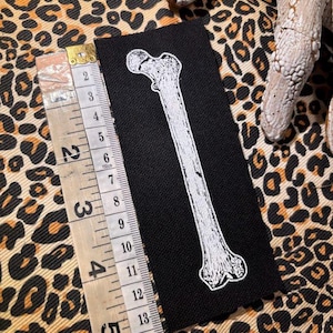 small human femur bone sew on punk patch.