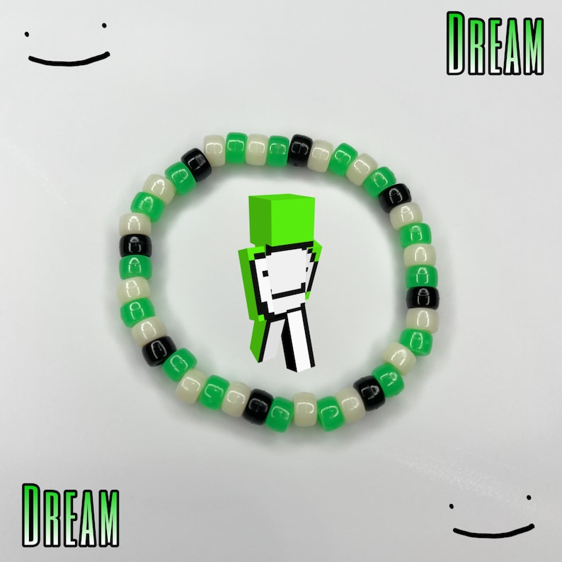 May include: Green, white, and black beaded bracelet with the word "DREAM" on either side of the image. A green Minecraft character is in the center of the bracelet.