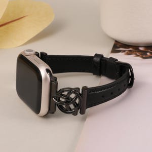 Black leather iWatch band with stainless steel trinity knot, a perfect blend of elegance and strength.