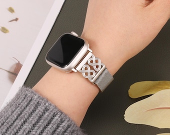 May include: A silver metal watch band with a linked chain design. The band is compatible with Apple Watch.
