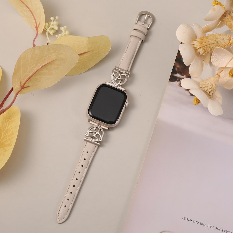 Side view of soft cream leather Apple Watch band with unique handcrafted Celtic knot detail.