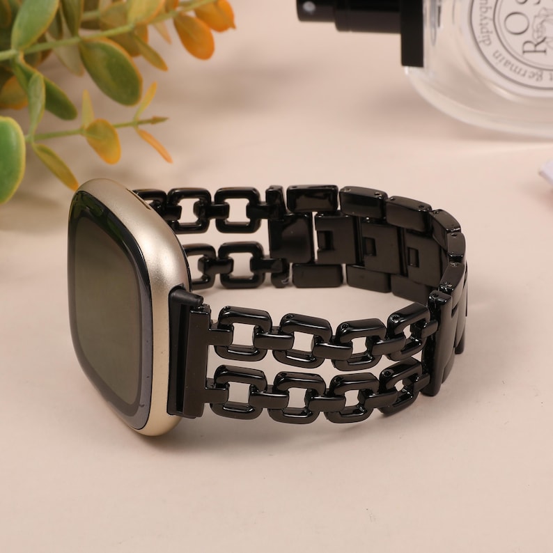 close-up of gold chain Fitbit watch band