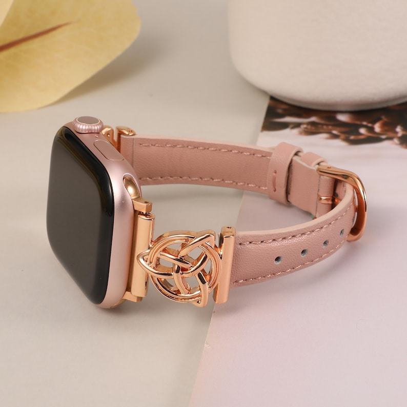 Detail shot of triquetra knot on iWatch strap, symbolizing eternal connection and feminine power.