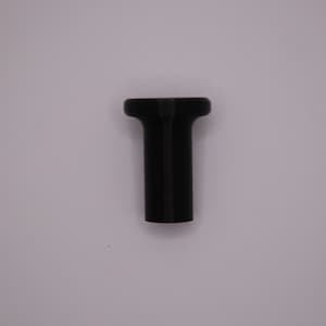 May include: A black plastic plug with a round top and a cylindrical body.