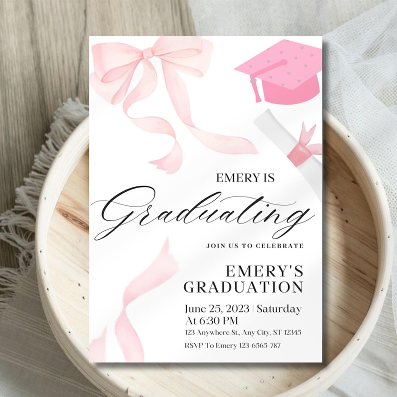 May include: Pink graduation invitation with a pink bow, graduation cap, and diploma. The text reads "Emery is Graduating. Join us to celebrate. Emery's Graduation. June 25, 2023 Saturday at 6:30 PM. 123 Anywhere St., Any City, ST 12345. RSVP To Emery 123-6565-787"