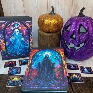 May include: Two Halloween themed journals with stained glass style covers. One journal features a ghost in a stained glass window, the other features a hooded figure in a forest. Both journals are surrounded by smaller stickers with similar designs.