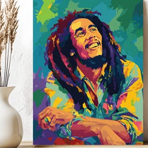May include: A vibrant pop art style portrait of a smiling man with long dreadlocks. The artwork features a colorful palette of blues, greens, yellows, and purples. The man is wearing a patterned shirt and a ring on his finger.