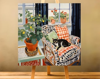 May include: A painting of a cozy interior scene. A black and white cat rests on a patterned armchair. A potted plant sits on a small table, and a window with flowers and curtains is in the background. The painting is displayed on a wooden easel.