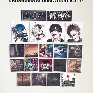 May include: A collection of 18 black and white album stickers featuring the band Dadaroma. The stickers are arranged in a grid on a white wall. The band's name is written in black and white on two larger stickers at the top of the grid. The stickers feature various album covers with different designs and images.