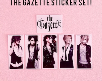 May include: A set of five stickers featuring black and white photos of the members of the Japanese rock band The Gazette. The band's name is written in a gothic font on a separate sticker.