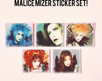 May include: A set of five stickers featuring black and white images of a Japanese rock band, Malice Mizer. The stickers are printed on a white background with a vintage, faded look. The band members are wearing elaborate makeup and costumes.