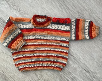 Hand knitted baby jumper. Multicoloured.