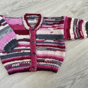 Hand knitted baby cardigan in Pinks, Grey & Cream. 3-6 months.