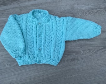 Hand knitted baby cable cardigan in Turquoise Blue. 0-3 mths.