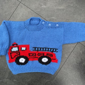 Hand knitted baby jumper in Blue with Fire Engine. 2 sizes.