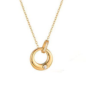 May include: A gold-colored pendant necklace featuring a circular design with a small, clear gemstone at the center. The pendant is connected to a delicate chain. A smaller, gem-studded bar connects to the circle.