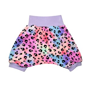 Op de afbeelding: Paarse en roze tie-dye stoffen shorts met een zwarte luipaardprint. De shorts hebben een brede elastische tailleband.