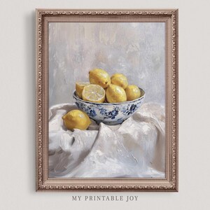 May include: A painting of a bowl of lemons on a white tablecloth. The bowl is blue and white with a floral pattern. The lemons are yellow and some are cut in half.
