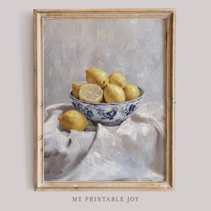 May include: A painting of a bowl of lemons on a white tablecloth. The bowl is blue and white with a floral pattern. The lemons are yellow and some are cut in half.