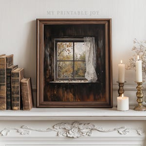 Könnte beinhalten: Ein gerahmter Druck eines Fensters mit Blick auf Herbstbäume und einem Spitzengardinen. Der Druck befindet sich in einem dunklen Holzrahmen und steht auf einem weißen Kaminsims mit Kerzen und antiken Büchern. Der Text "MY PRINTABLE JOY" steht oben.