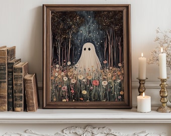 May include: A framed art print featuring a whimsical ghost in a white sheet standing in a field of wildflowers. The background shows a dark forest with a glowing light. The print is in a brown wooden frame. The text "MY PRINTABLE JOY" is at the top.