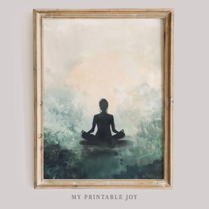 May include: A framed print of a watercolor painting featuring a silhouette of a person meditating in a yoga pose against a background of soft blue and green watercolor washes.