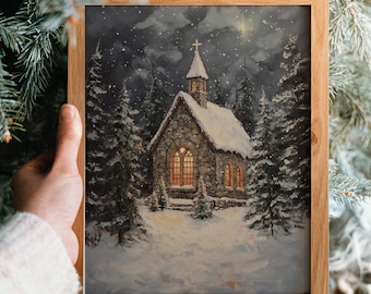 May include: A framed print of a snowy church scene. The stone church has a cross on top and lit windows. The artwork is set in a snowy forest with evergreen trees. The frame is made of light-colored wood. The text "MY PRINTABLE JOY" is at the bottom.