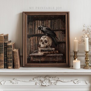 May include: A framed print shows a black raven on a skull, atop books, against a backdrop of a bookshelf. The artwork has a dark, gothic aesthetic. The text "MY PRINTABLE JOY" is visible at the top of the frame. The overall style is reminiscent of a vintage library.