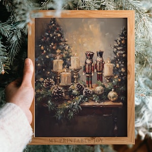 May include: A framed print featuring a Christmas still life. The artwork depicts a table adorned with candles, pinecones, ornaments, and two toy nutcrackers. The background shows Christmas trees with lights. The frame is made of wood.