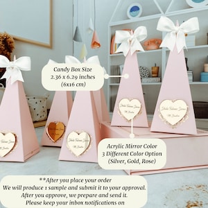 May include: Pink pyramid-shaped candy boxes with white bows and a heart-shaped mirror with the text "Dhaka Falveer Drone" in gold. The boxes are 2.36 x 6.29 inches (6x16 cm). The mirror is available in silver, gold, or rose.