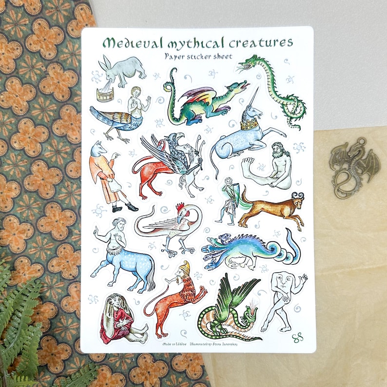 May include: A sticker sheet featuring various medieval mythical creatures, including dragons, unicorns, and centaurs. The sheet has the text "Medieval mythical creatures" and "Paper sticker sheet" in a decorative font. The illustrations are in a vintage style.