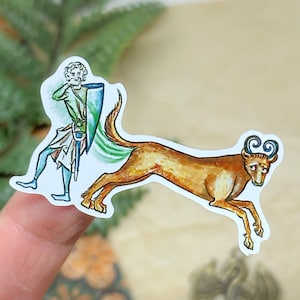 May include: A sticker featuring a medieval illustration of a figure in green and blue clothing with a shield and sword, chasing a brown deer-like creature with curly horns. The sticker has a white border.