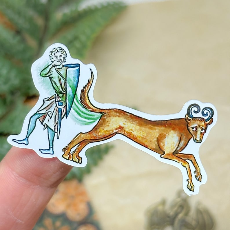 May include: A sticker featuring a medieval illustration of a figure in green and blue clothing with a shield and sword, chasing a brown deer-like creature with curly horns. The sticker has a white border.
