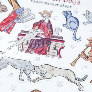May include: A sheet of paper stickers featuring medieval-style illustrations of dogs. The stickers depict dogs in various poses, including one wearing a crown and another playing a musical instrument. The text "Paper sticker sheet" is visible at the top.
