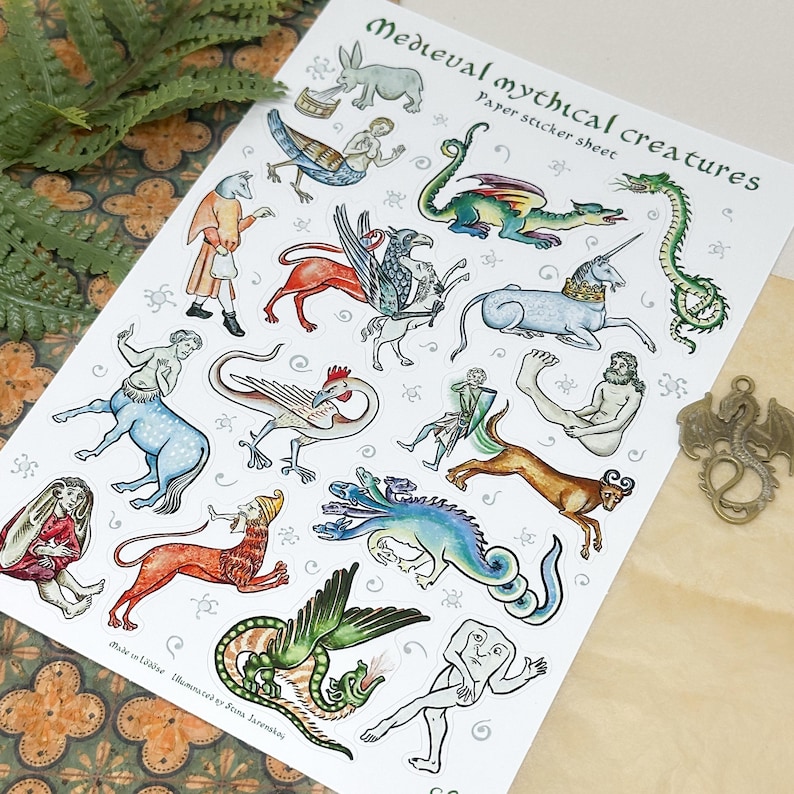 May include: A sheet of paper stickers featuring medieval mythical creatures. The stickers include illustrations of a unicorn, dragon, mermaid, centaur, and other fantastical beings. The text "Medieval mythical creatures" is printed at the top.