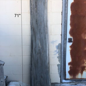 May include: A weathered gray wood plank, 2 inches thick and 71 inches long, labeled "R1".