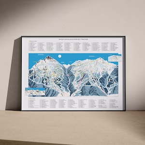 May include: A framed Whistler Blackcomb ski tracker print featuring a detailed mountain map with blue skies, white snow, and dark grey rock faces. The poster includes numbered lists for Blackcomb and Whistler runs, along with two inset maps.